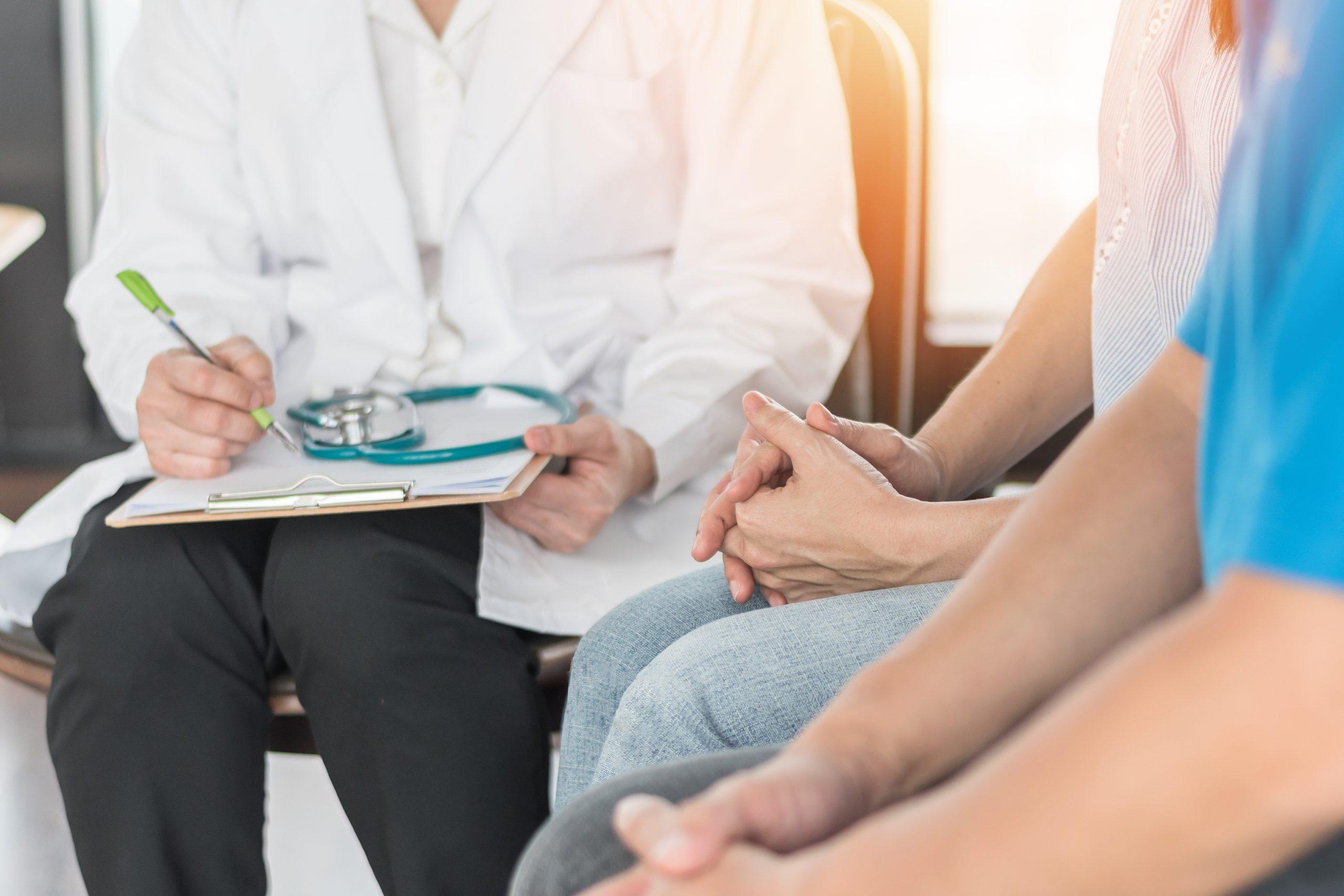 Patient couple consulting with doctor or psychologist on marriage counseling, family medical healthcare therapy, In vitro fertility IVF treatment for infertility, or psychotherapy session concept